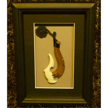 Framed traditional Maori bone and wood hook
