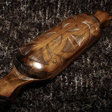wooden waka huia with carved lid